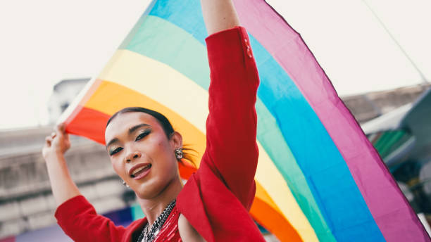 istock Young diverse having fun holding LGBT rainbow flag outdoor. 2156582019
