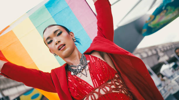 istock Young diverse having fun holding LGBT rainbow flag outdoor. 2156582021