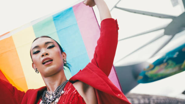 istock Young diverse having fun holding LGBT rainbow flag outdoor. 2156582022