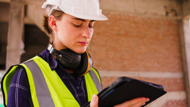 istock Young Female Building Architect Use a Tablet Computer on a City Construction Site. 2156582135