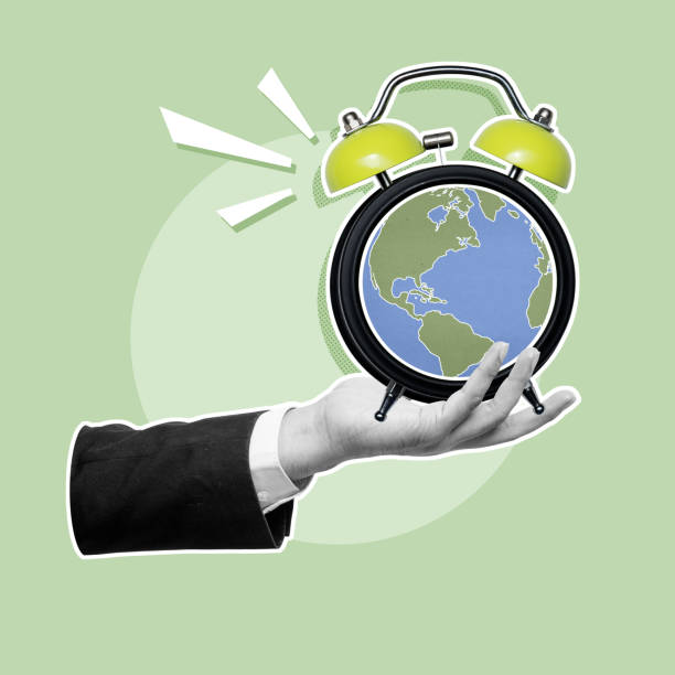 istock Business hand showing alarm clock with a globe on the clock face 2156582627