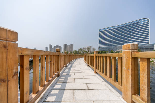 istock Empty wooden boardwalk and lakeside residential buildings 2156584080