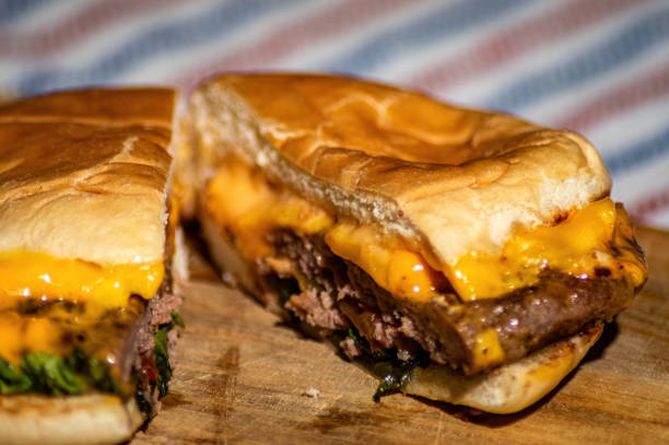 istock a beef cheese burger that is split with a knife filled with meat, tomato sauce, mayonnaise and lettuce that looks delicious and tempting to make your stomach hungry 2156589551