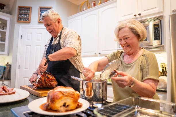 istock Senior friends preparing a dinner in the kitchen 2156593268