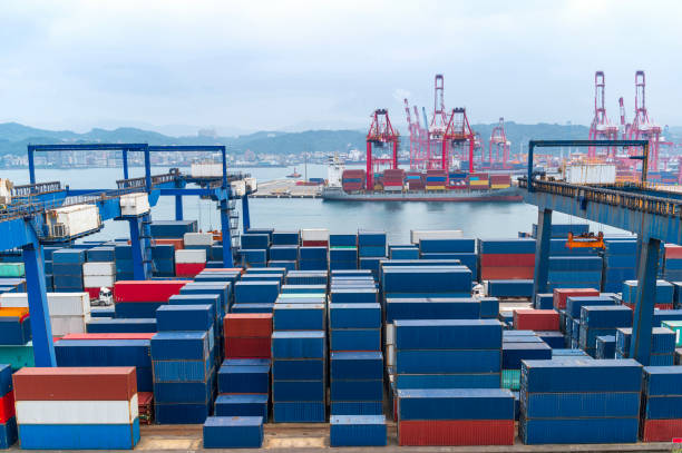 istock Port container cranes loading with multi-colored containers for worldwide shipping by sea transport at container ship in the cargo terminal of Keelung Asia port  Harbor, Taiwan. 2156593908