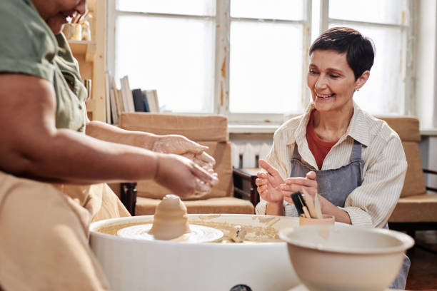 istock Art Teacher Assisting Student in Art Studio 2156595374
