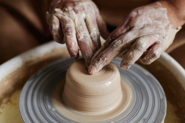 istock Close Up Hands Shaping Clay on Pottery Wheel 2156595380