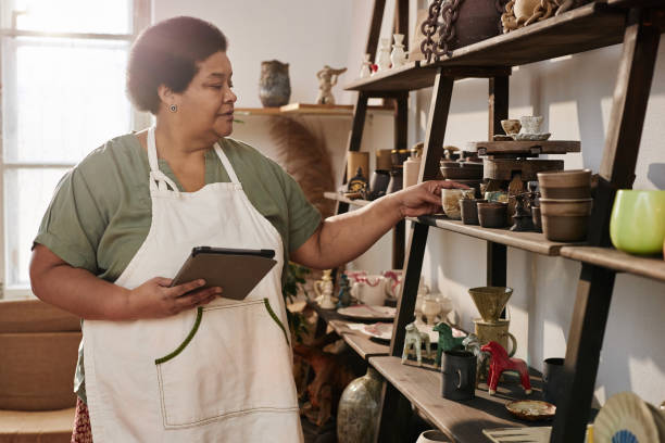 istock Black Senior Woman Using Tablet in Art Studio 2156595421