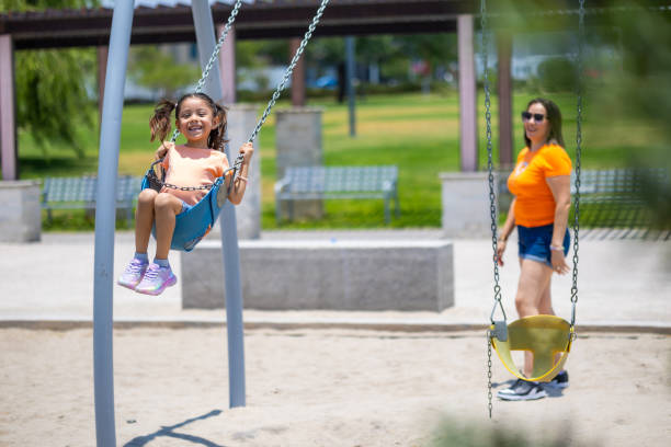 istock Mom and daughter playing in the park 2156597171