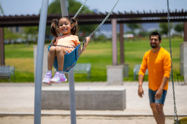 istock Father and daughter playing in the park 2156597191