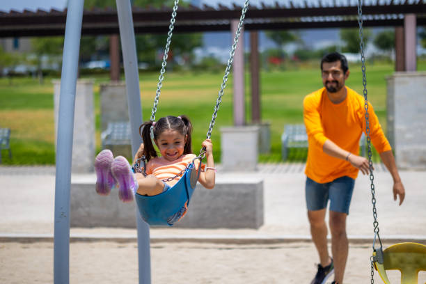 istock Father and daughter playing in the park 2156597193