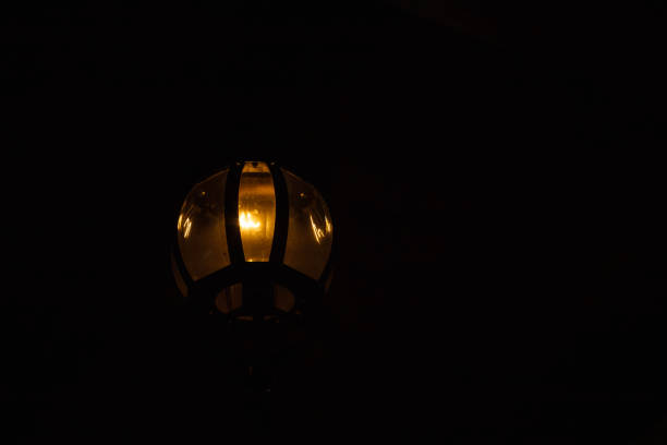 The light of the retro stylized lantern on the background of a red ceiling. Copy space.