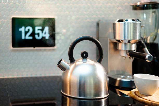 Sunrise light dappling onto a country kitchen gas range with red kettle