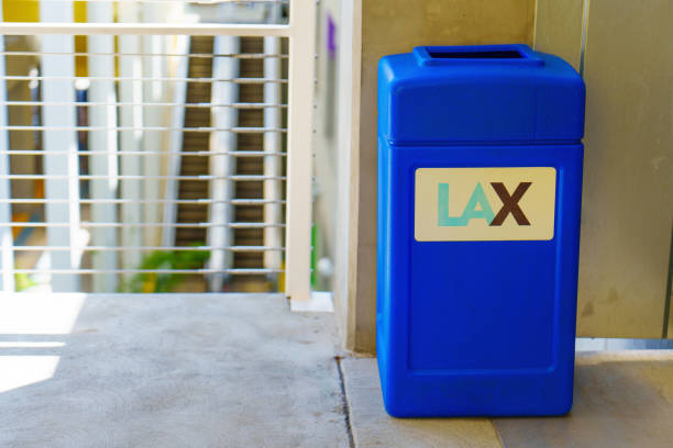 Los Angeles, California - April 9, 2024: Bright blue waste bin in the LAX parking lot, symbolizing cleanliness and order in the facility.