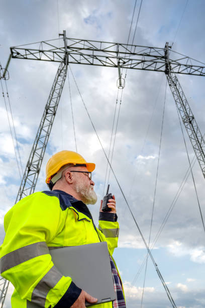 istock Electrical engineer using laptop and walkie-talkie in electrical substation 2156601148