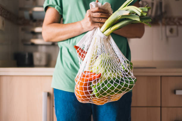 istock Woman with Fresh Vegetables in Eco-friendly Bag. 2156602753