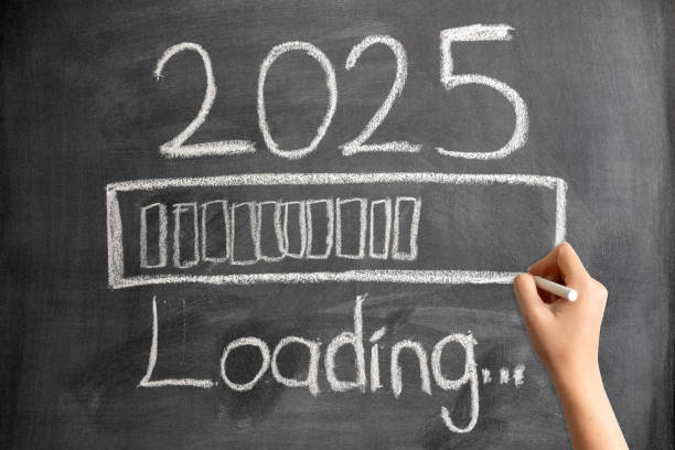istock Loading New Year 2025 on Blackboard with Woman Hand 2156603635