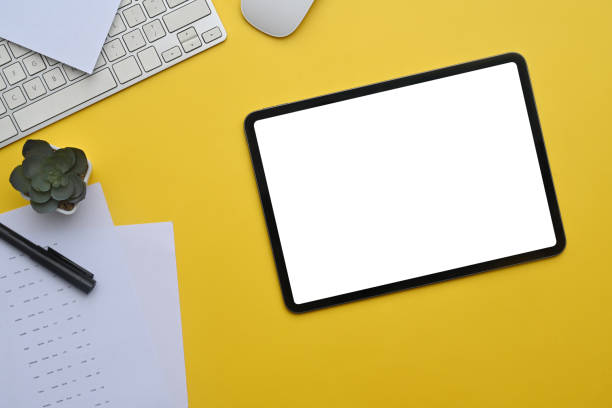istock Digital tablet on yellow background with keyboard and potted plant 2156607379