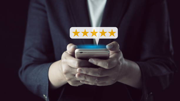 istock Customer Experiences Concept.Using Smartphone to Submit Five Star Review Rating for Online Satisfaction Surveys. Positive Feedback on Mobile Phone 2156608228