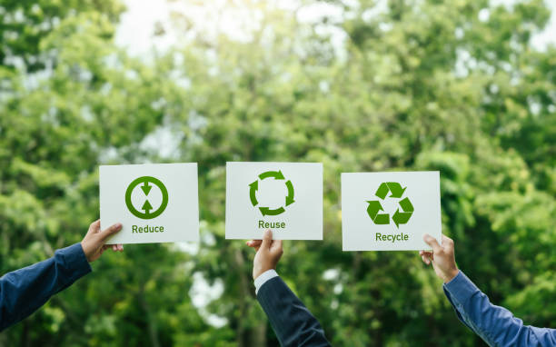 istock Business team holding a sign recycle reuse reduce on nature background for zero waste concept and environmental sustainability. CSR corporate social responsibility. eco friendly design product 2156608434