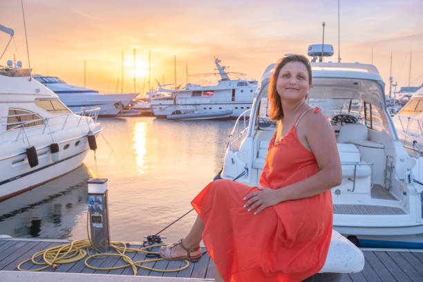 istock Beautiful young woman in a marina. 2156610461