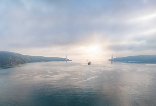 Aerial view of cargo container ship in transit in Istanbul Bosphorus. Aerial view of freight ship with cargo containers. Container ship is crossing the Bosporus in Istanbul, Turkey.