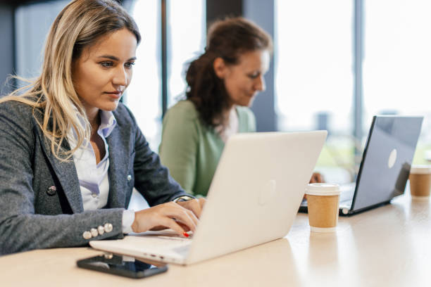 istock Two women working on their laptops 2156612928