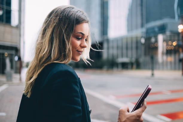 istock Businesswoman Checking Phone in Urban Setting 2156614237