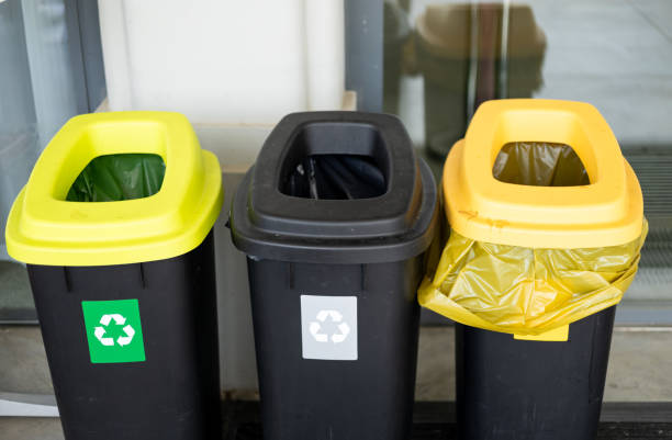 istock Colorful trash cans for sorting garbage. For plastic, glass, paper and others waste. Waste containers for garbage segregation in Poland, standing next to a wall 2156619302