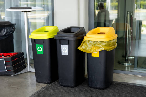 istock Colorful trash cans for sorting garbage. For plastic, glass, paper and others waste. Waste containers for garbage segregation in Poland, standing next to a wall 2156619335