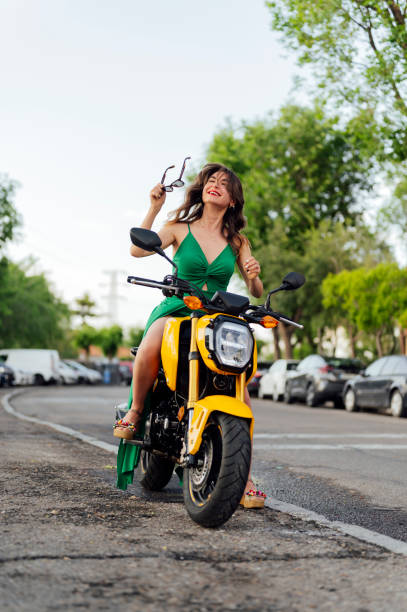 istock An attractive young woman sitting on her motorcycle 2156620861