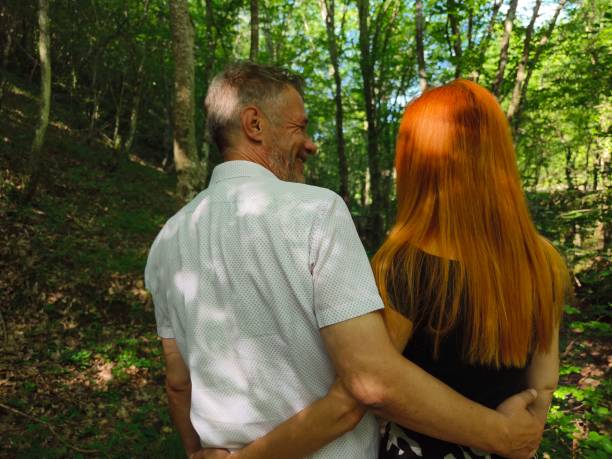 Couple in love enjoy beautiful summer day in the forest