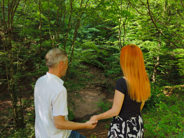 Couple in love enjoy beautiful summer day in the forest