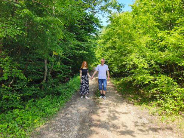 Couple in love enjoy beautiful summer day in the forest