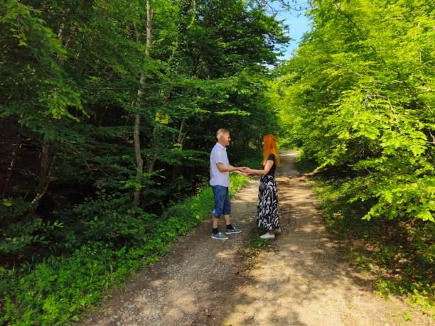 Couple in love enjoy beautiful summer day in the forest