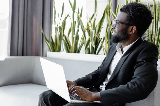 istock Businessman using laptop for work while sitting on chair in office 2156622741