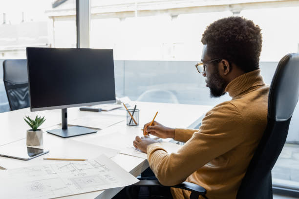istock Professional man architect designing professional architects plans for clients in the office 2156622783