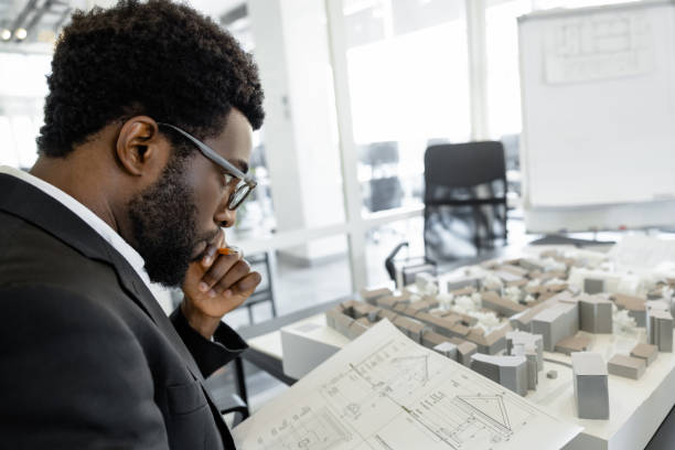 istock Detail-oriented man architect preparing for presentation in his modern workplace 2156622814