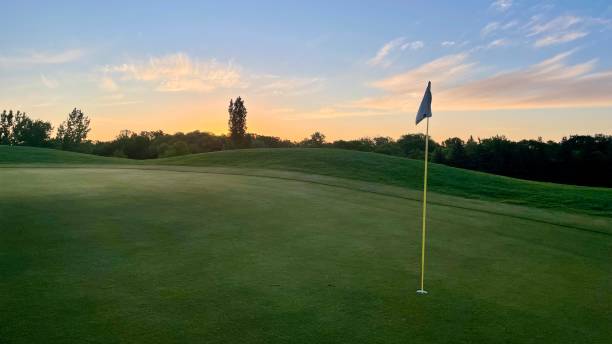 Early morning sunrise over golf course green