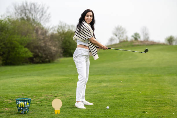 istock Woman playing golf at golf course enjoying leisure time 2156625570