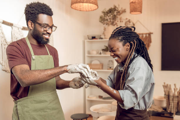 istock Two people in a pottery workshop looking contented and happy 2156628366