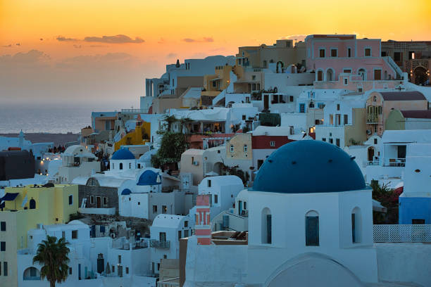 Sunset view at Oia at Santorini, GreeceTourists have been blurred on the photo
