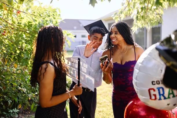 istock Graduate waving to family on a smartphone screen 2156641189
