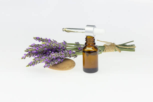 istock Amber essential lavender oil bottle. Pipette with drop and bottle on an isolated background. 2156641969