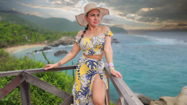 istock Beautiful woman walking on the seashore 2156644800