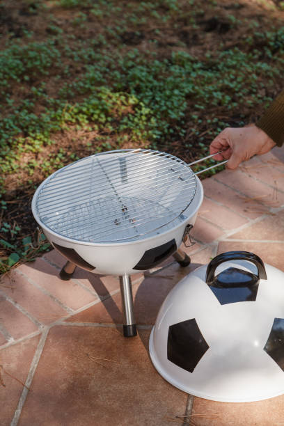 istock Hand sets grill in round barbecue 2156650687