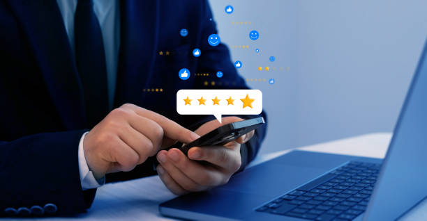 istock Satisfaction, quality and performance.Businessman gives leave feedback on the bought product with five star rating. Review customer satisfaction feedback 2156655257