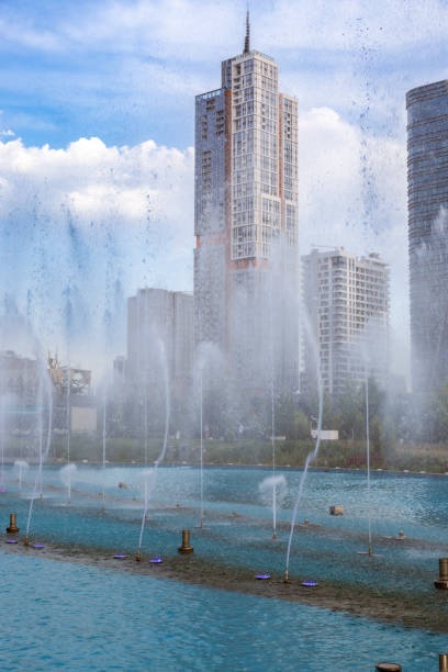 View of the pond and fountain at Tashkent City Park, new public park in the city, with the country’s tallest building to date  in the background