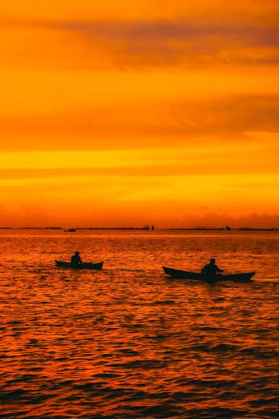 two anglers fishing at sunset is very aesthetic