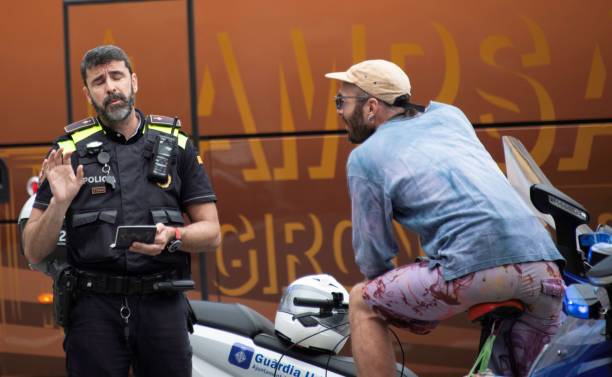 Barcelona, Spain - 05 25 2024: a Barcelona traffic police officer is controlling a male bicycle rider for traffic violation